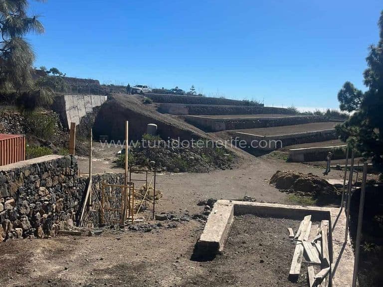 Agricultural terraces with stone walls and dirt ground