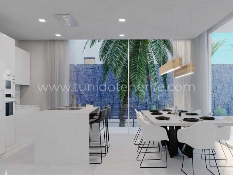 Open kitchen with dining area and large windows to garden