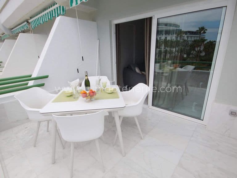Terrace with table, chairs and sliding glass door