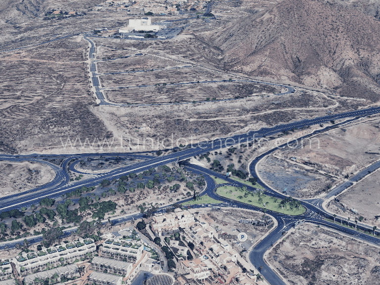 Arid landscape with roads, roundabout and partial development