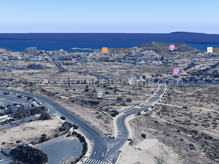 Aerial view of roads, roundabout and arid coastal landscape