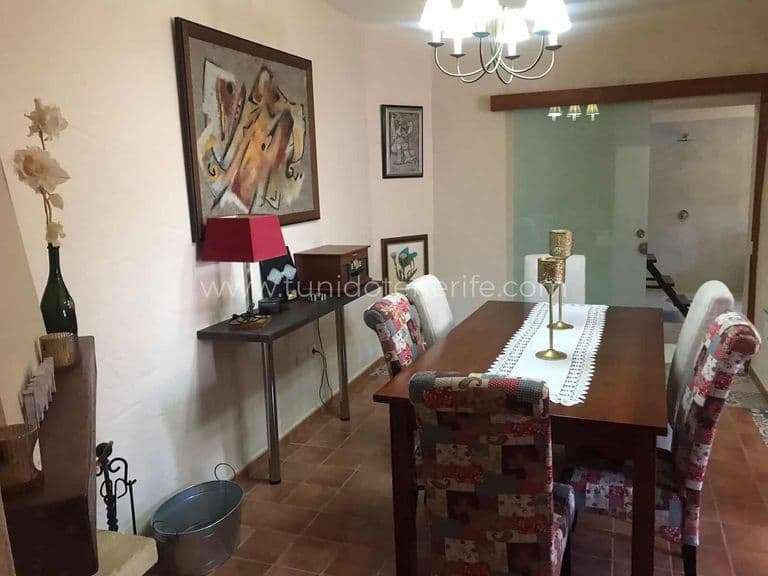 Dining room with table, upholstered chairs and ceiling light