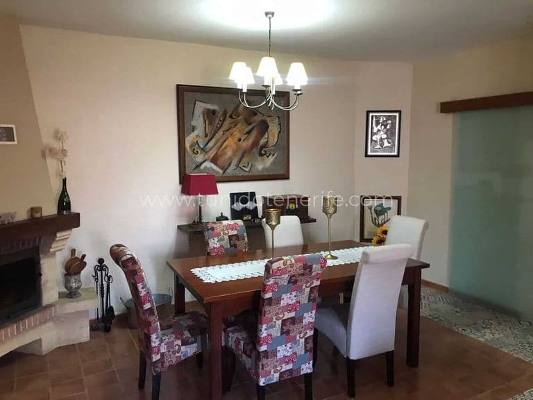 Dining room with wooden table and upholstered chairs
