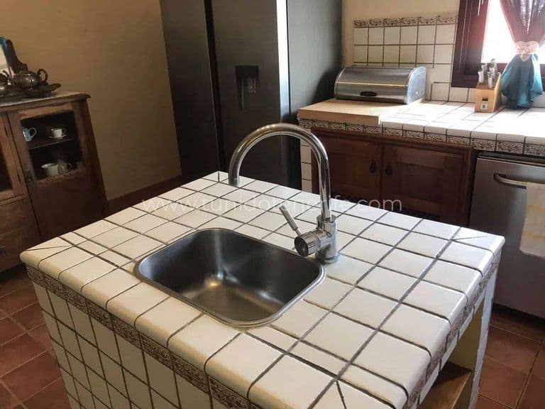 Kitchen with central island and stainless steel sink