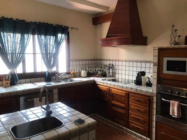 Kitchen with wooden cabinets and tiled countertop