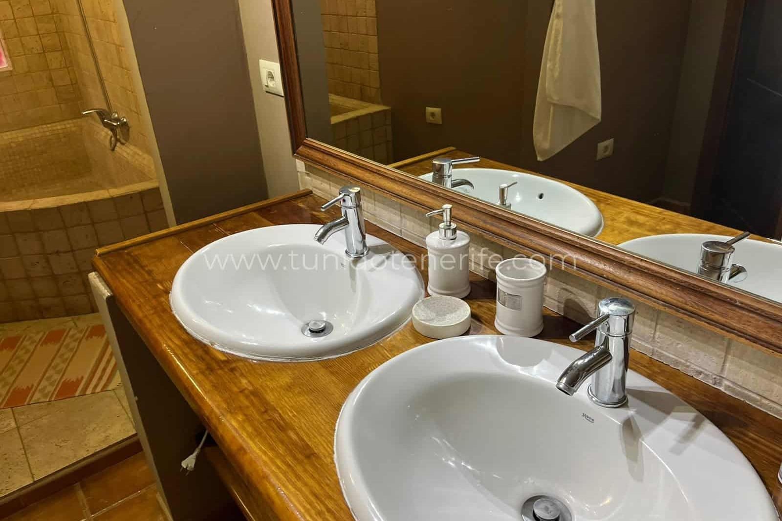Bathroom with double sink and large mirror