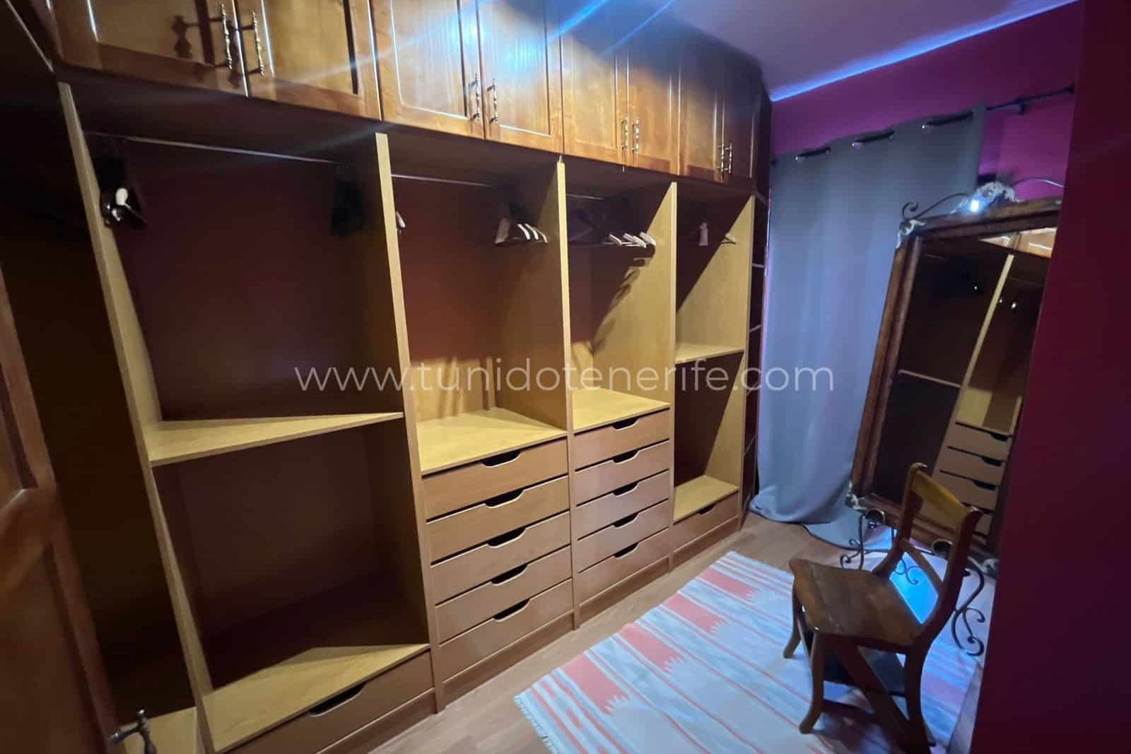 Dressing room with wooden built-in wardrobes and mirror