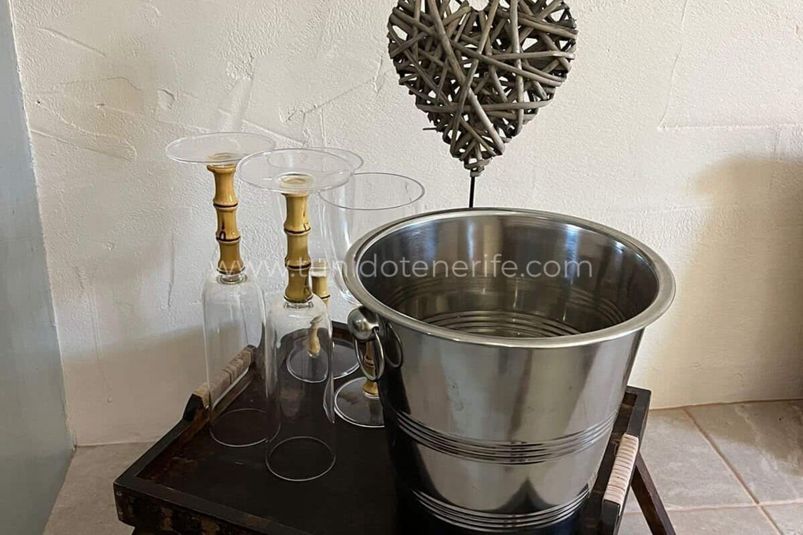 Metal ice bucket with glasses and decorative candlesticks