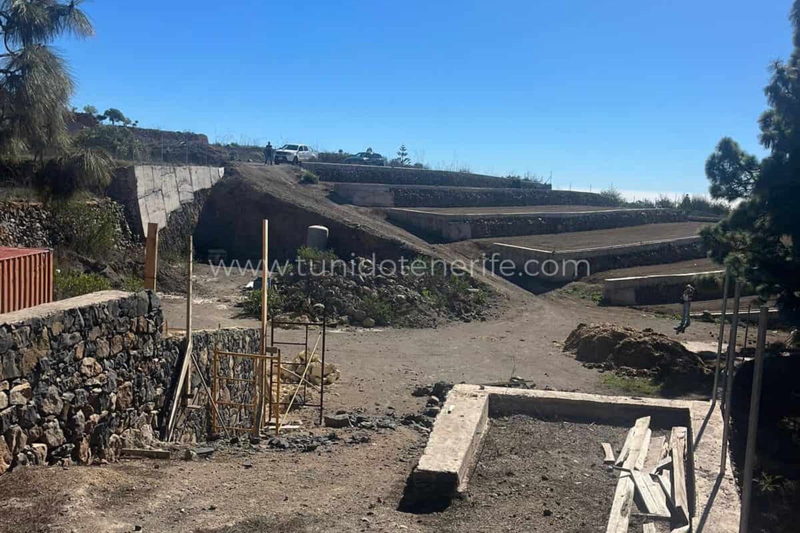 Agricultural terraces with stone walls and dirt ground