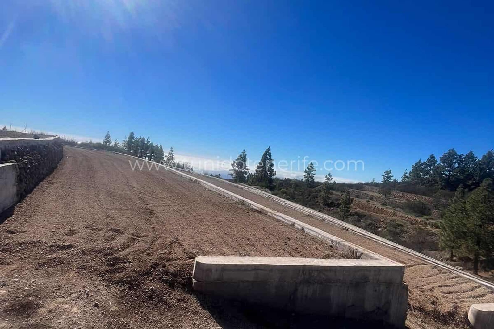 Leveled plot with concrete access and clear sky
