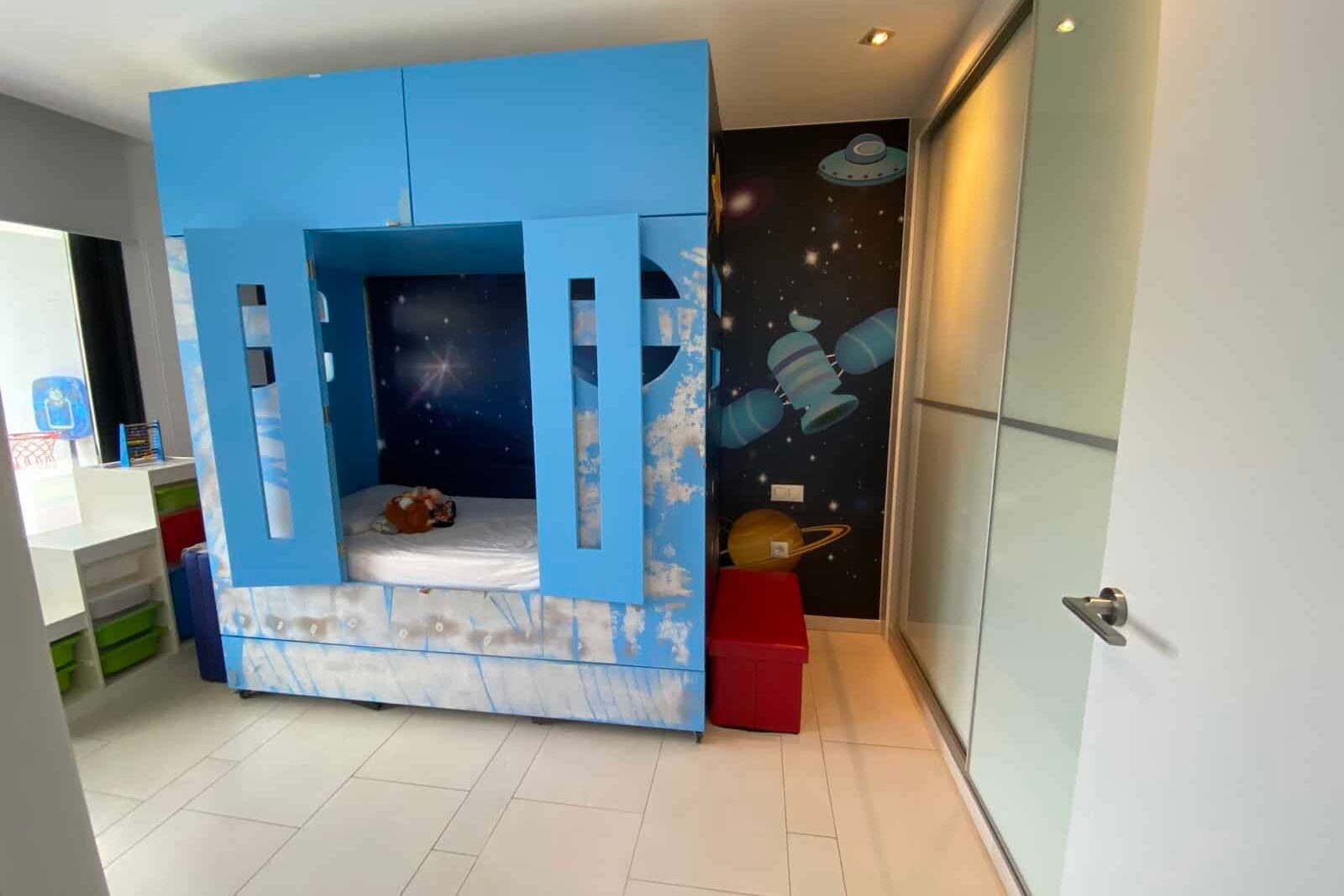 Children's play area with blue module and space murals