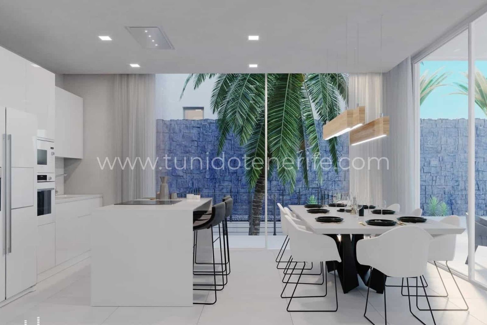 Open kitchen with dining area and large windows to garden
