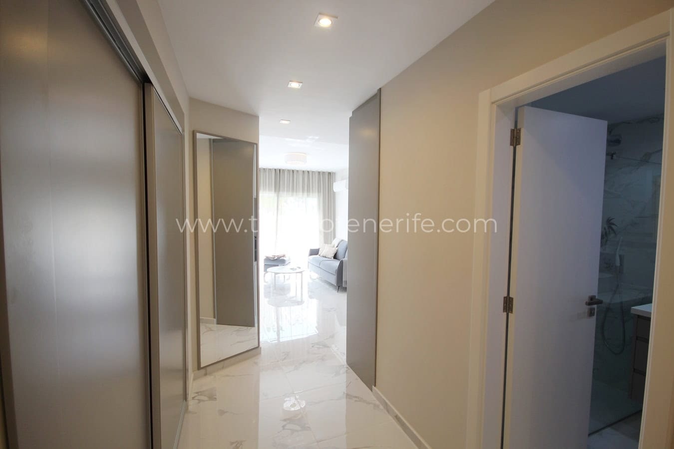 Bright hallway with built-in wardrobes and access to living room