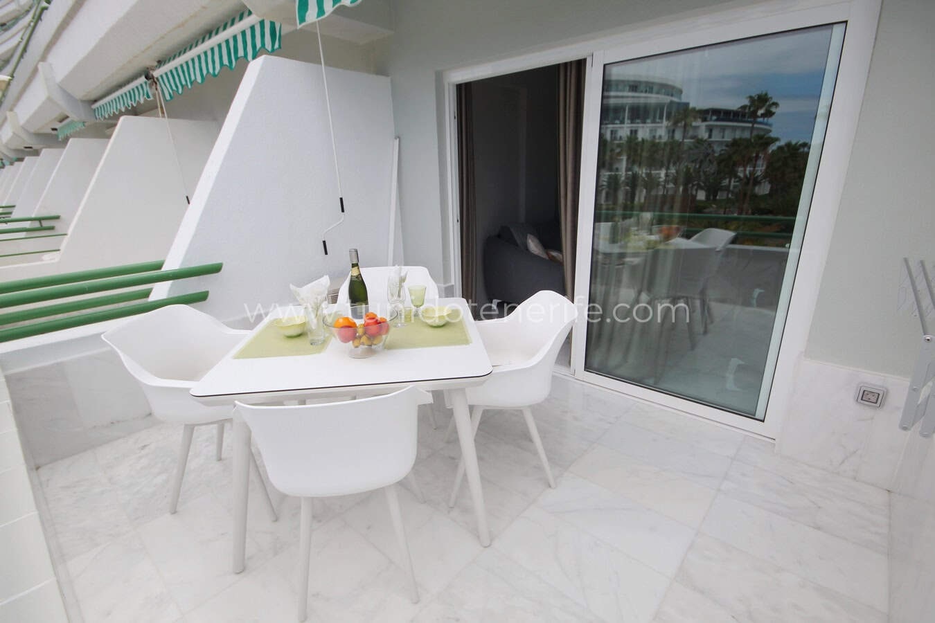 Terrace with table, chairs and sliding glass door