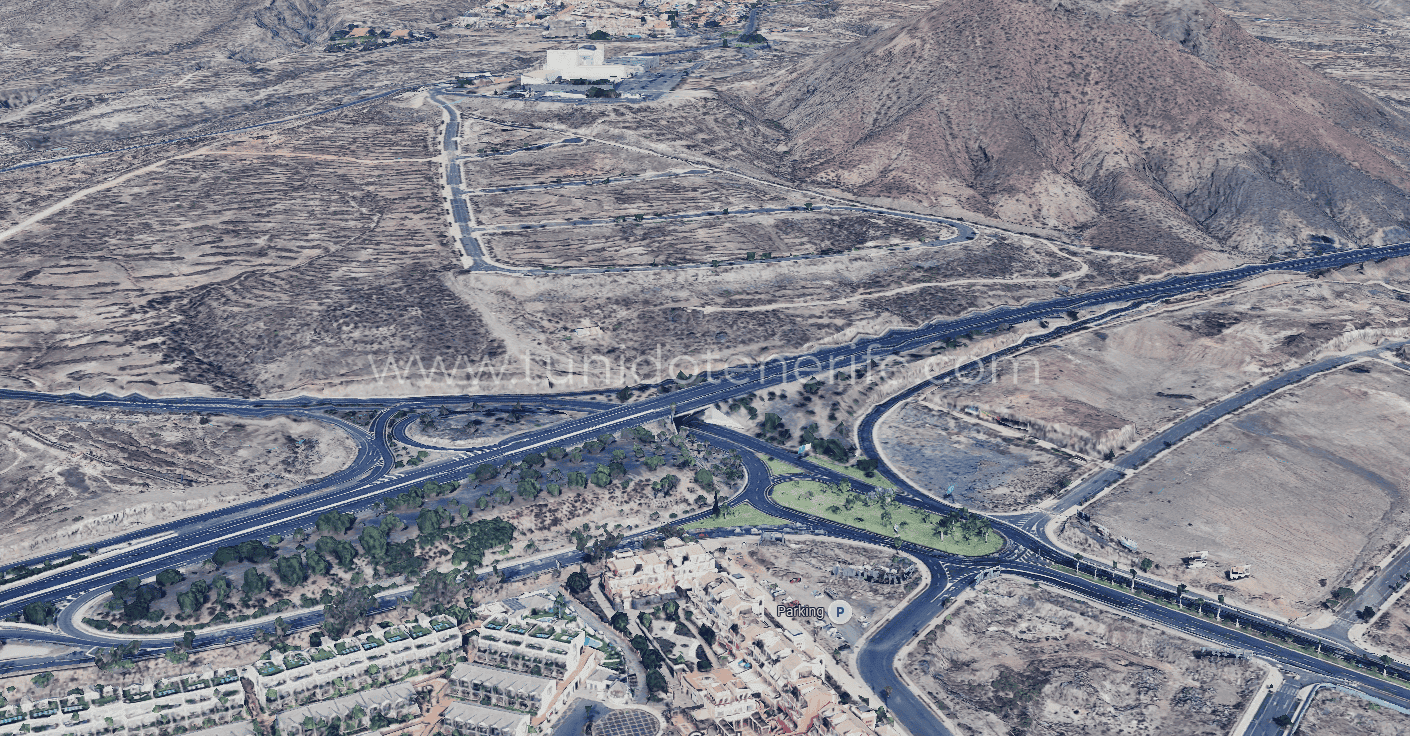 Arid landscape with roads, roundabout and partial development