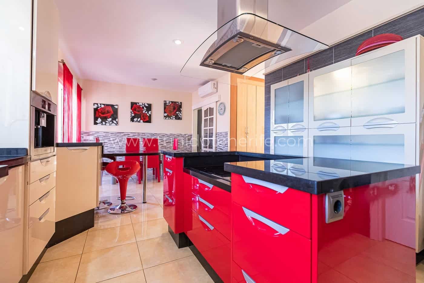 Cuisine moderne avec meubles rouges et plan de travail noir