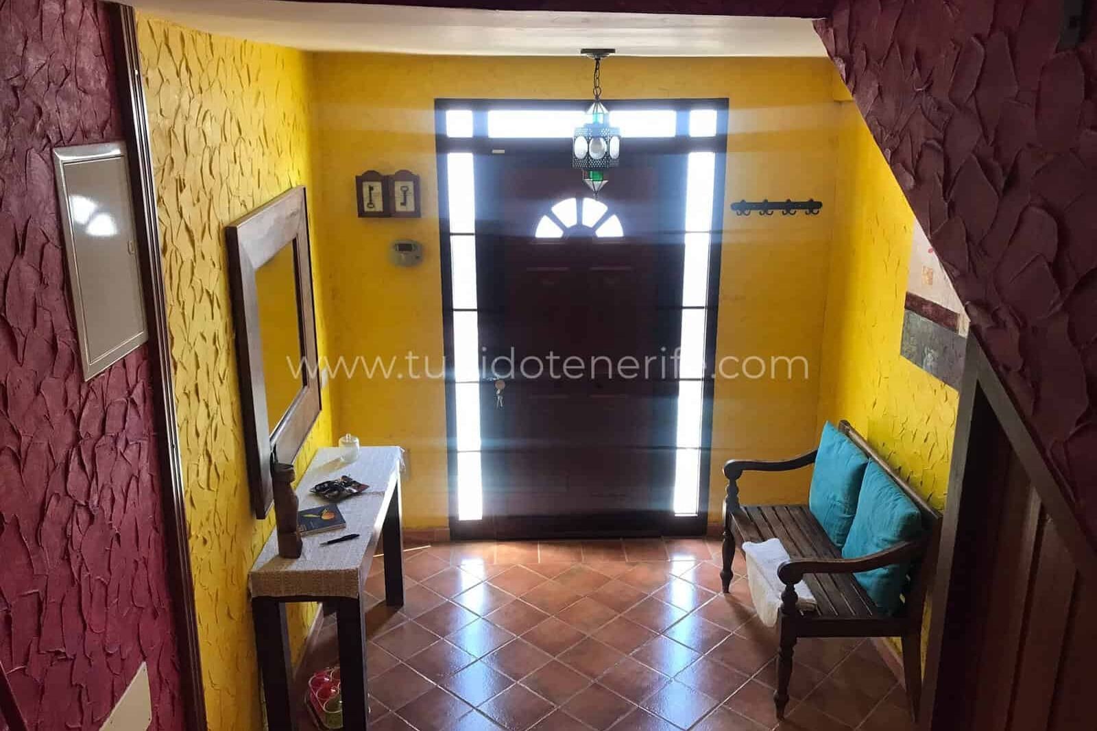 Hallway with front door, bench and mirror