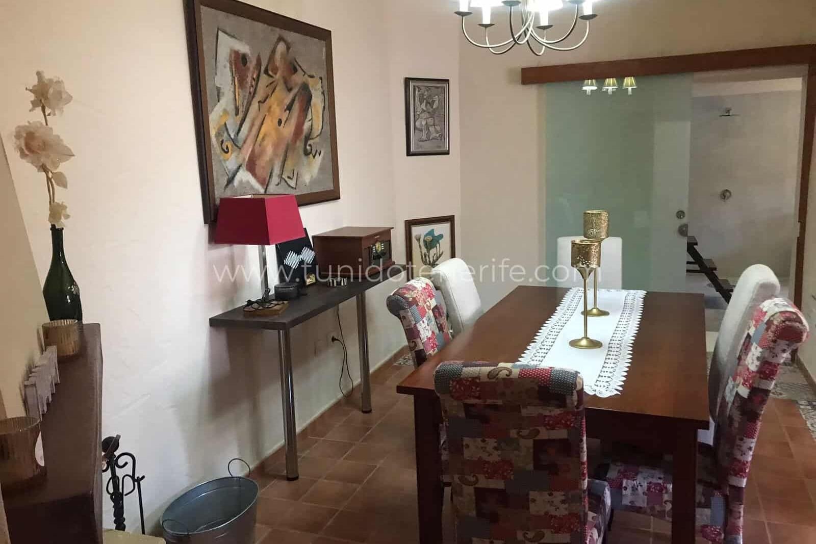 Dining room with table, upholstered chairs and ceiling light