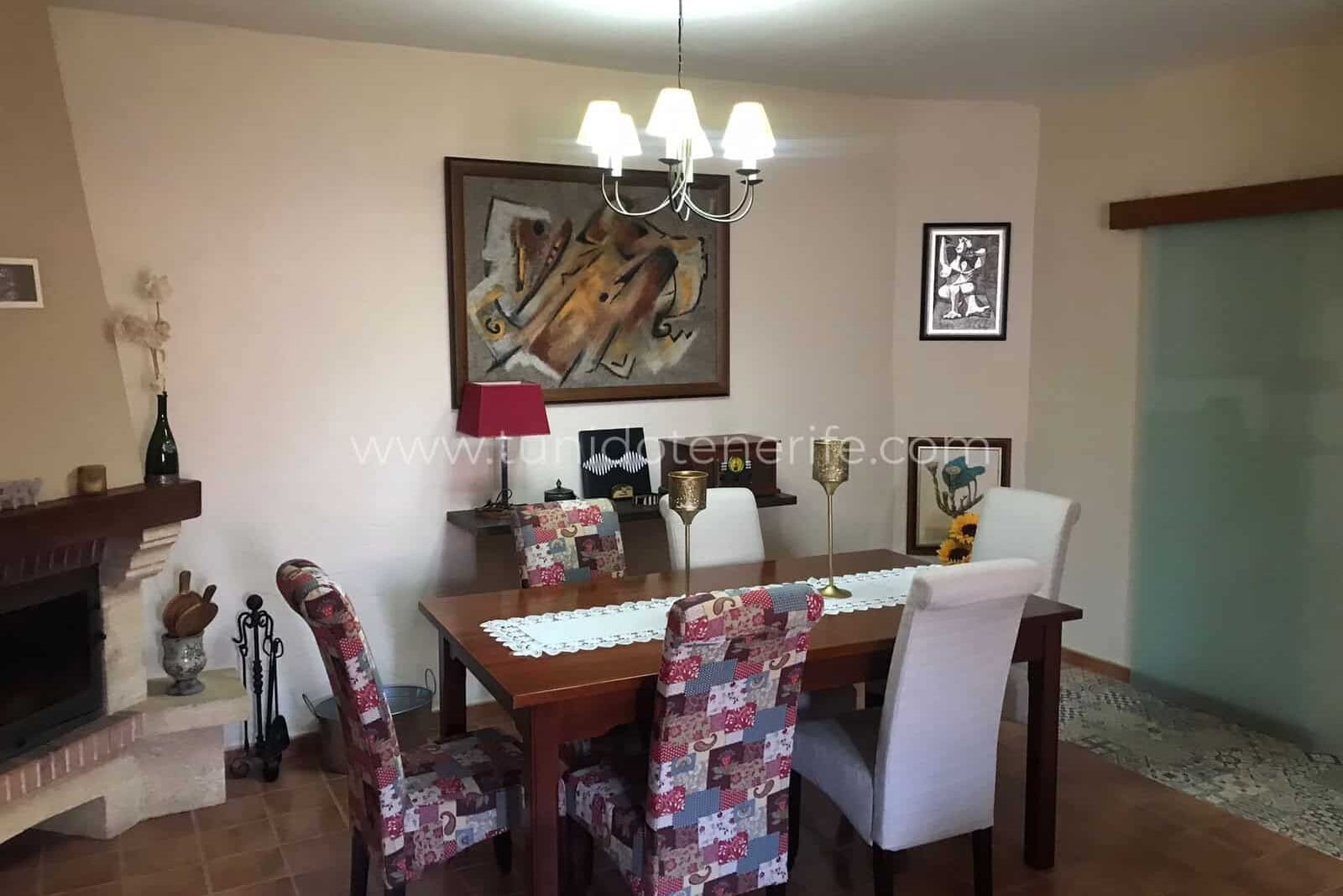 Dining room with wooden table and upholstered chairs
