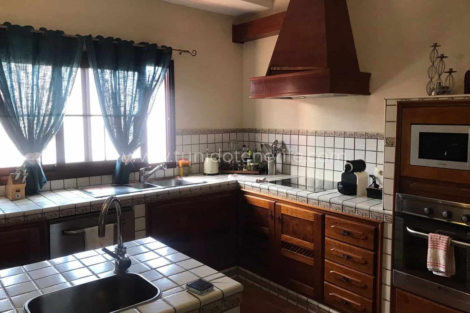 Kitchen with wooden cabinets and tiled countertop