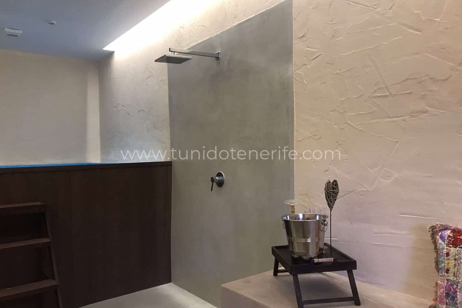 Shower area with tiled wall and sink