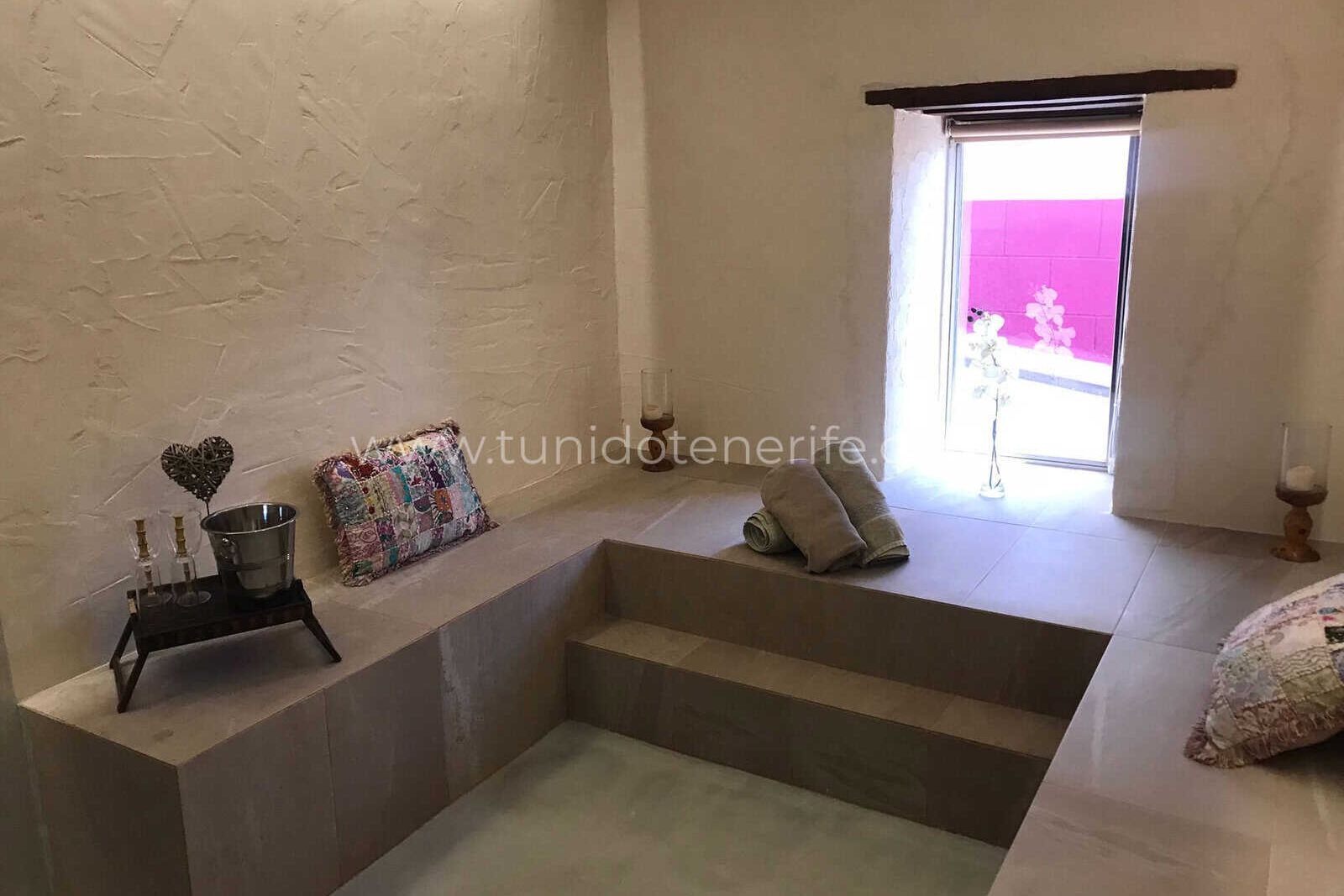 Living room with built-in sofa and small window