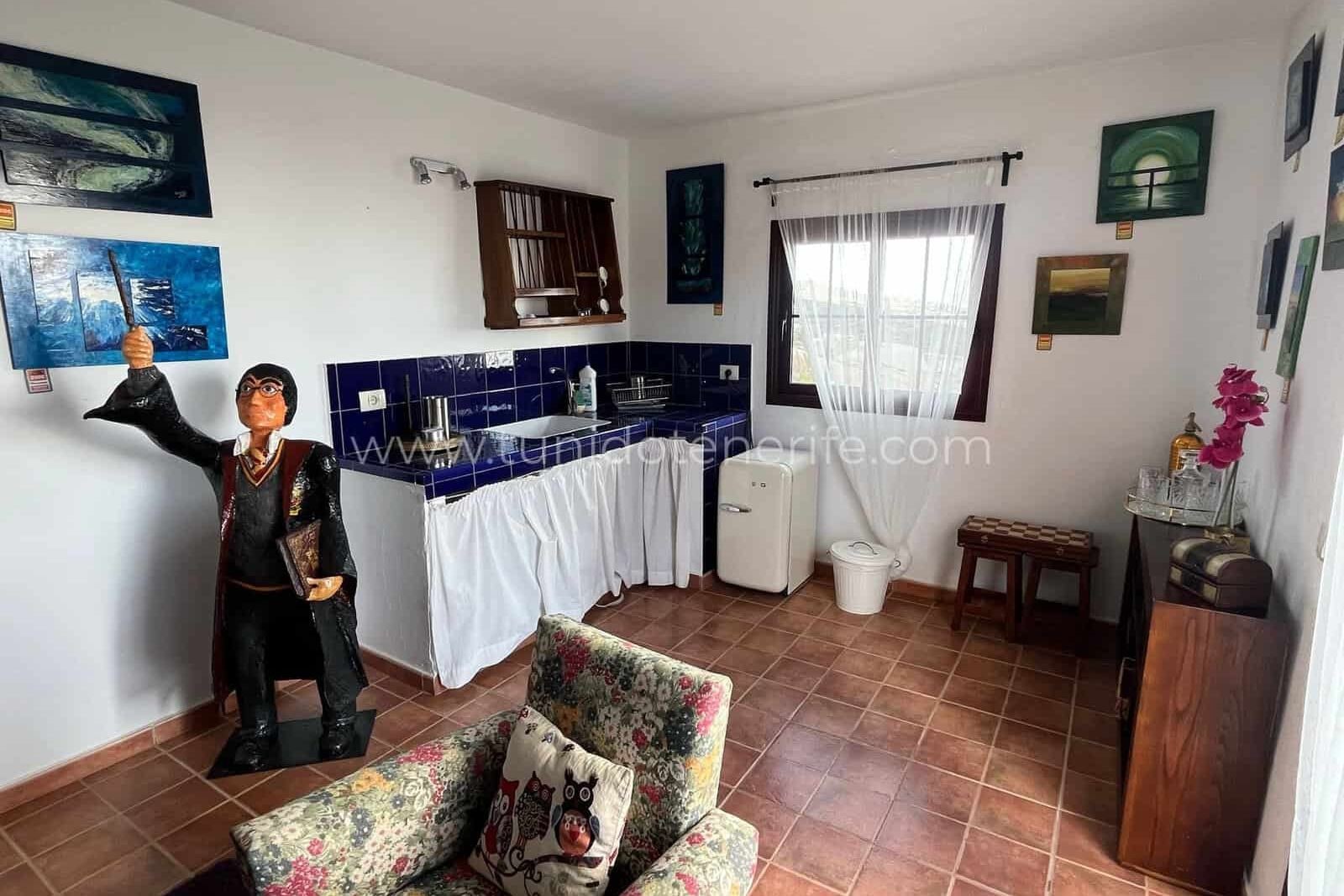 Living room with floral sofa, blue bar and window