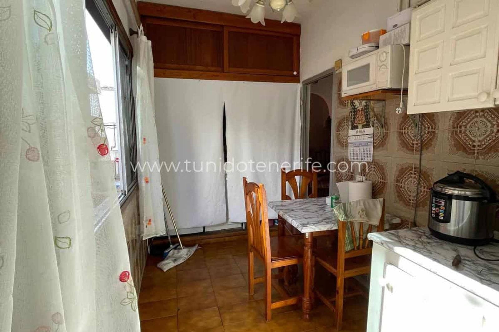Kitchen with dining table and white cabinets