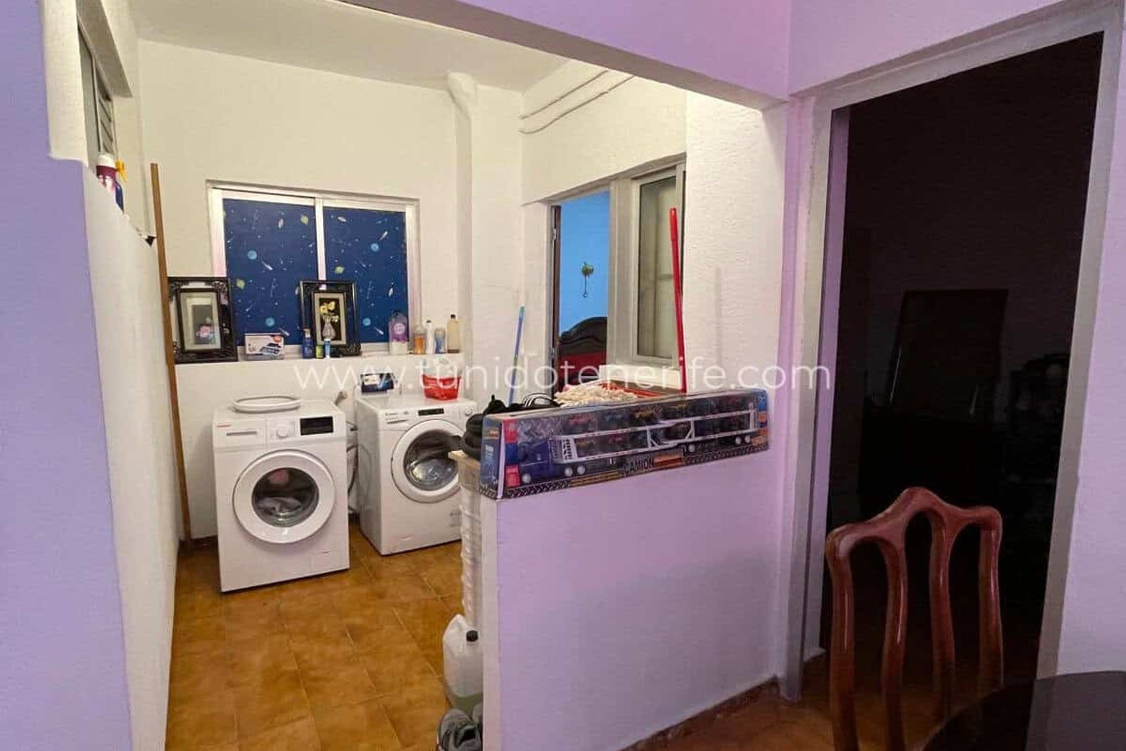 Laundry room with washing machine, dryer and window