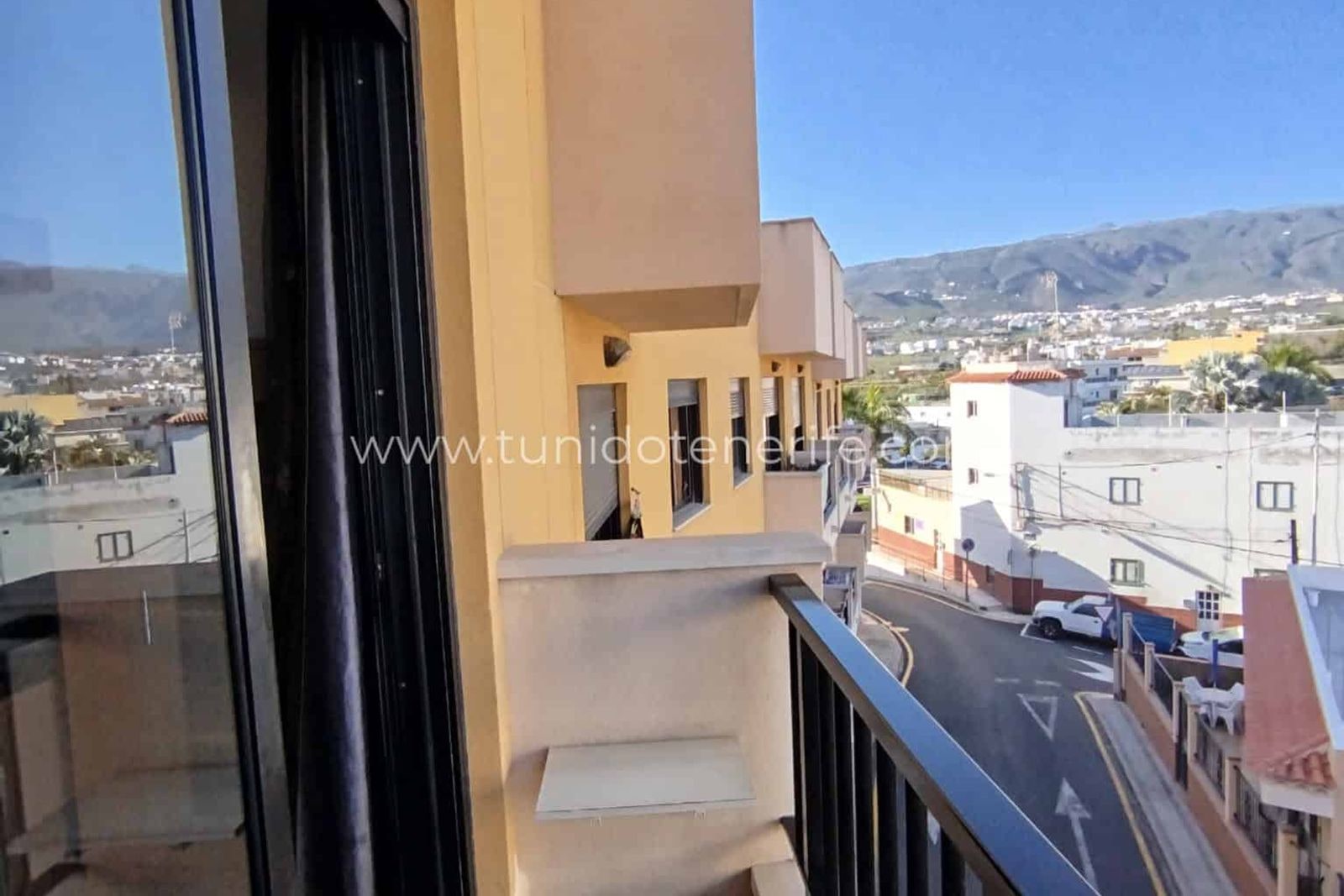 Balcón con vistas a la calle y montañas