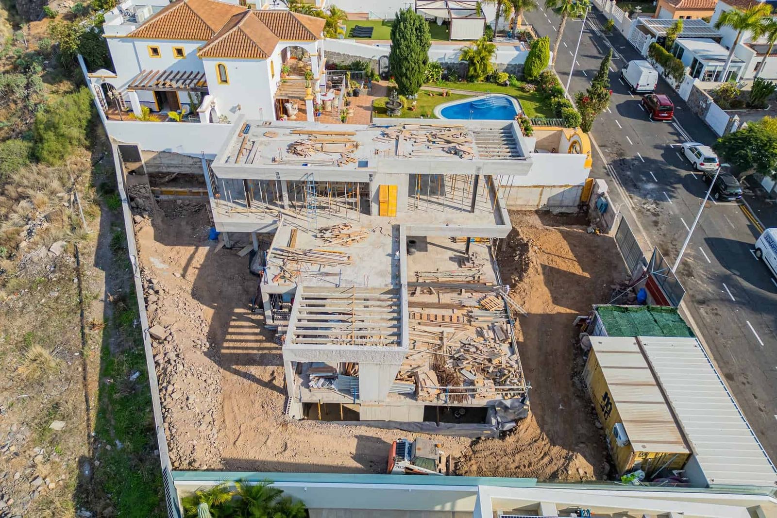 House under construction with concrete structure and debris