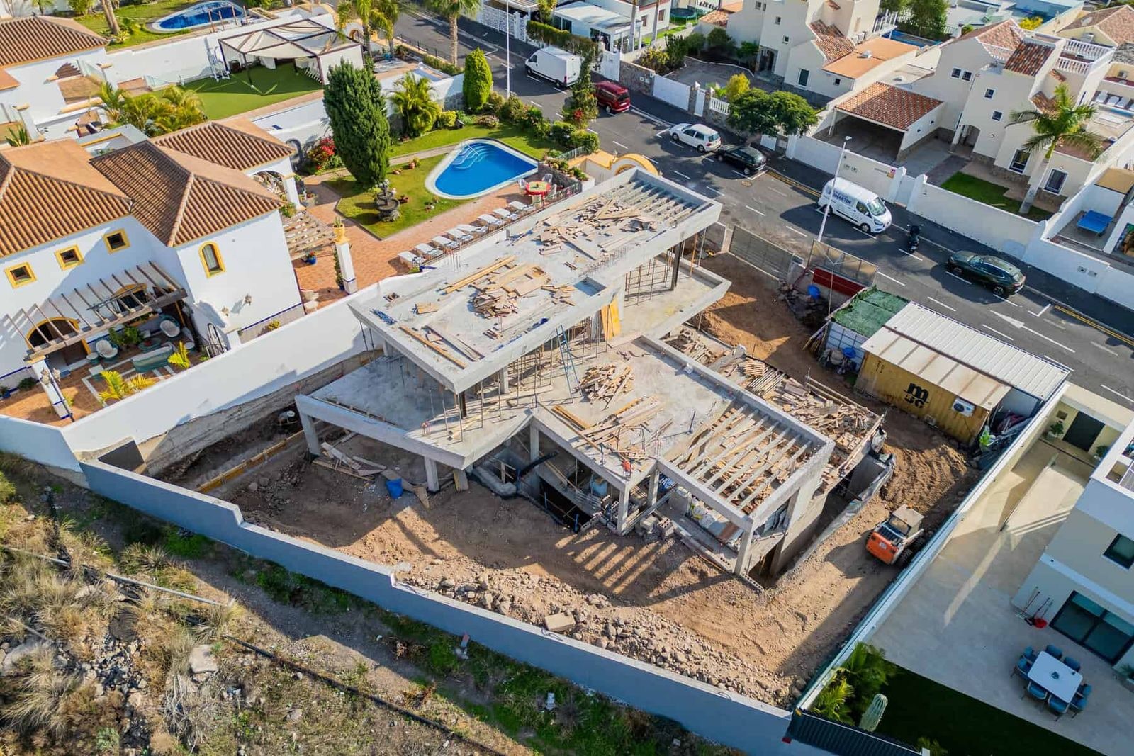 House under construction with concrete structure and plot